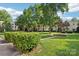 Well-maintained common area with green lawn, trimmed shrubs, and a walkway with planted tree at 1121 Myrtle Ave # 72, Charlotte, NC 28203