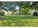 Lush green common area with manicured lawn and mature shade trees surrounding the apartment complex at 1121 Myrtle Ave # 72, Charlotte, NC 28203