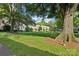 Well-kept green lawn, mature shade trees and building exterior within the well-maintained common area at 1121 Myrtle Ave # 72, Charlotte, NC 28203
