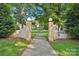 An inviting community entrance featuring manicured landscaping and mature trees at 1121 Myrtle Ave # 72, Charlotte, NC 28203