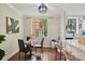 Chic dining area with sleek black table and chairs, hardwood floors, and bright natural lighting at 1121 Myrtle Ave # 72, Charlotte, NC 28203