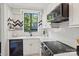 Bright kitchen with white herringbone backsplash, stainless steel appliances, and a view of the outdoors at 1121 Myrtle Ave # 72, Charlotte, NC 28203
