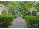 Inviting walkway leading to an address featuring well-maintained greenery and mature shade trees on either side at 1121 Myrtle Ave # 72, Charlotte, NC 28203