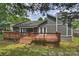 Back exterior view showcasing the spacious deck, patio, and grey siding at 11619 Rimrock Canyon Dr, Charlotte, NC 28226