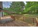 Large wooden deck extends to a well-kept backyard with mature trees at 11619 Rimrock Canyon Dr, Charlotte, NC 28226