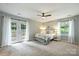 Bright bedroom features a French door, a ceiling fan, and ample natural light at 11619 Rimrock Canyon Dr, Charlotte, NC 28226
