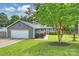 Inviting exterior view of home featuring fresh landscaping and mature tree at 11619 Rimrock Canyon Dr, Charlotte, NC 28226