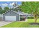 Charming exterior features a well-manicured lawn and an attached garage at 11619 Rimrock Canyon Dr, Charlotte, NC 28226