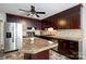 Modern kitchen featuring stainless steel appliances, granite countertops, and custom cabinetry at 11619 Rimrock Canyon Dr, Charlotte, NC 28226