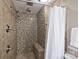 Tiled shower with mosaic accent wall, bench, and dual shower heads at 11619 Rimrock Canyon Dr, Charlotte, NC 28226
