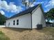 Rear exterior showcasing siding, new roof, new construction and surrounding trees at 1312 7Th St, Statesville, NC 28677