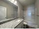 Modern bathroom featuring granite vanity, chrome fixtures, and a shower-tub combination at 1312 7Th St, Statesville, NC 28677