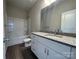 Bathroom featuring granite countertop, white cabinets, tub and vinyl floors at 1312 7Th St, Statesville, NC 28677