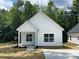 Charming one-story home with white siding, a covered porch, and a well-manicured lawn at 1312 7Th St, Statesville, NC 28677