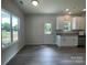 Bright living room features modern kitchen, wood floors and light streaming through large windows at 1312 7Th St, Statesville, NC 28677