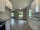 Open floor plan with modern kitchen, wood floors, and natural light streaming through windows at 1312 7Th St, Statesville, NC 28677