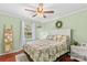 Inviting bedroom with a floral-patterned comforter, white furniture, and a window with sheer curtains at 149 Harbor Landing Dr, Mooresville, NC 28117
