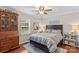 Comfortable bedroom with a wooden bed frame, dresser, and ample natural light from the window at 149 Harbor Landing Dr, Mooresville, NC 28117