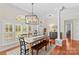 Inviting dining room with wood floors, natural light, and contemporary chandelier at 149 Harbor Landing Dr, Mooresville, NC 28117