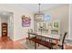 Bright dining room featuring wood floors, large windows, and modern lighting at 149 Harbor Landing Dr, Mooresville, NC 28117