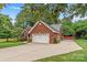 Brick home with a two-car garage, spacious driveway, and well-maintained front yard at 149 Harbor Landing Dr, Mooresville, NC 28117