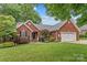 Charming brick home with manicured lawn, two-car garage, and inviting front entrance at 149 Harbor Landing Dr, Mooresville, NC 28117