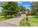 Charming brick home with well-maintained lawn, mature trees, and a two-car garage, offering great curb appeal at 149 Harbor Landing Dr, Mooresville, NC 28117