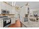 Well-lit kitchen with stainless steel appliances, granite countertops, and wood floors at 149 Harbor Landing Dr, Mooresville, NC 28117