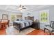 Spacious main bedroom featuring a tray ceiling, dark wood furniture, and natural light at 149 Harbor Landing Dr, Mooresville, NC 28117