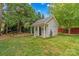 Charming outbuilding featuring a private backyard, lush lawn, and convenient garage door at 149 Harbor Landing Dr, Mooresville, NC 28117