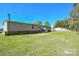 Back of the home with a view of its wide lawn at 1574 Burke Duncan Rd, Lancaster, SC 29720