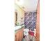 This bathroom features a toilet, a sink, and a shower with a colorful polka dot shower curtain at 1574 Burke Duncan Rd, Lancaster, SC 29720