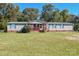 Charming single-story home with a green roof, front porch, and expansive front yard at 1574 Burke Duncan Rd, Lancaster, SC 29720