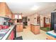 Open concept kitchen with island, wood cabinets, and view to living area for easy entertaining at 1574 Burke Duncan Rd, Lancaster, SC 29720