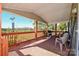 Relaxing covered porch with brick flooring, wood railing, and space for outdoor seating and grilling at 1574 Burke Duncan Rd, Lancaster, SC 29720