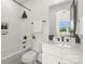 Bright bathroom with a tub, white vanity with marble countertop, and modern fixtures at 158 Mattoon St, Charlotte, NC 28216