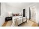 Comfortable bedroom with a metal bed frame, hardwood floors, and ensuite bathroom at 158 Mattoon St, Charlotte, NC 28216