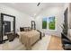 Modern bedroom with large window, stylish furnishings, a comfortable bed, and wooden flooring at 158 Mattoon St, Charlotte, NC 28216