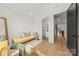 Bright bedroom with wood floors, a daybed, and views of an ensuite bathroom and hallway at 158 Mattoon St, Charlotte, NC 28216