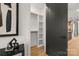 Walk-in closet with custom shelving, wood floors, and a modern black door at 158 Mattoon St, Charlotte, NC 28216