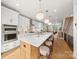 Bright kitchen with white cabinets, marble countertops, and modern gold pendant lighting at 158 Mattoon St, Charlotte, NC 28216