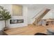 Bright living room with sleek fireplace, hardwood floors, and modern staircase at 158 Mattoon St, Charlotte, NC 28216