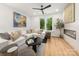Cozy living room with a white sectional sofa, decorative fireplace, and lots of natural light at 158 Mattoon St, Charlotte, NC 28216