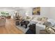 Open concept living room featuring a white sectional, hardwood floors, and lots of natural light at 158 Mattoon St, Charlotte, NC 28216