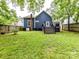A view of the backyard featuring a large lawn and rear entry at 1605 Allen St, Charlotte, NC 28205