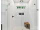 Bathroom shower with frameless glass door, wooden bench and white tile at 1605 Allen St, Charlotte, NC 28205