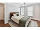 Cozy bedroom with neutral walls, hardwood floors, ceiling fan, and natural light from the windows at 1605 Allen St, Charlotte, NC 28205