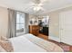 Bedroom featuring a walk-in closet, wood floors, and a comfortable bed at 1605 Allen St, Charlotte, NC 28205