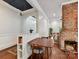 Cozy dining room with brick fireplace, hardwood floors, and a charming archway at 1605 Allen St, Charlotte, NC 28205