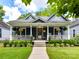 Charming home featuring a welcoming porch, lush landscaping, and classic architectural details at 1605 Allen St, Charlotte, NC 28205